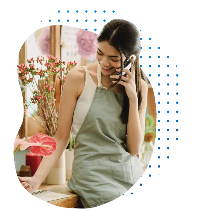 Florist and small business owner smiling while talking on the phone
